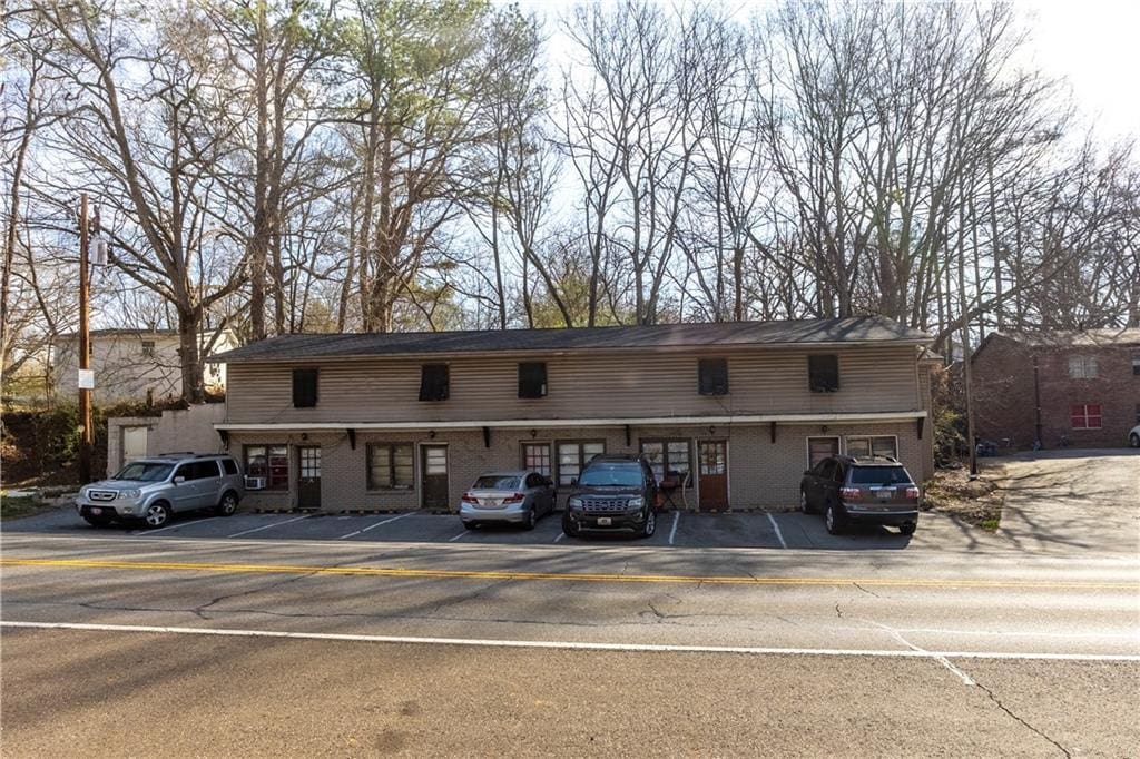 view of property with uncovered parking