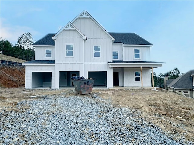 back of property featuring a garage and covered porch