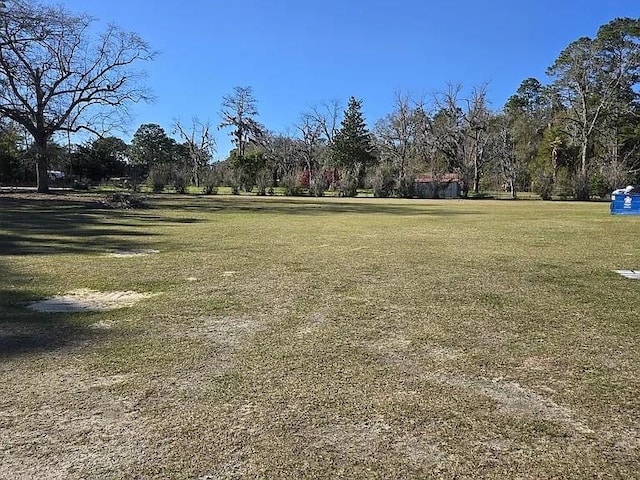 view of property's community with a lawn