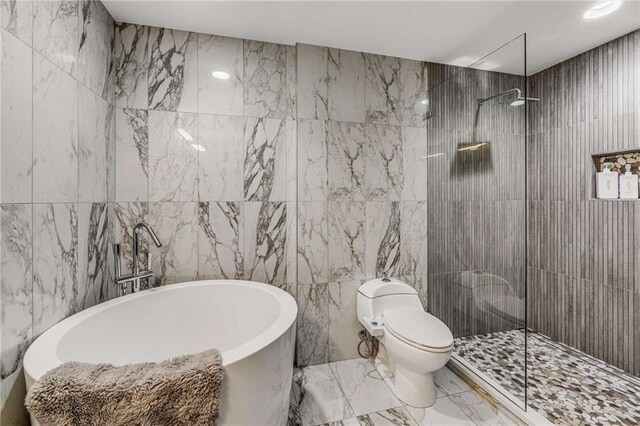 951 Glenwood Ave SE Unit 1805, Atlanta, GA 30316 - bathroom with tile walls, marble finish floors, walk in shower, a soaking tub, and toilet