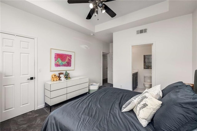 951 Glenwood Ave SE Unit 1805, Atlanta, GA 30316 - carpeted bedroom featuring a tray ceiling, baseboards, ceiling fan, and connected bathroom