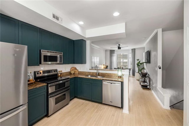 951 Glenwood Ave SE Unit 1805, Atlanta, GA 30316 - kitchen featuring appliances with stainless steel finishes, a sink, light wood finished floors, a peninsula, and recessed lighting