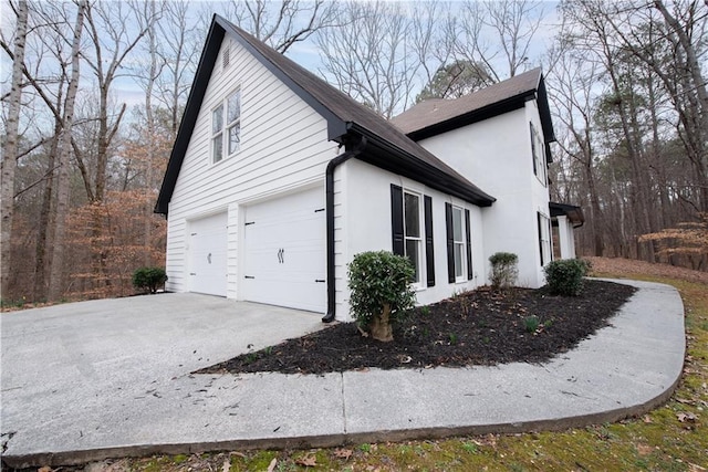 view of side of home featuring a garage