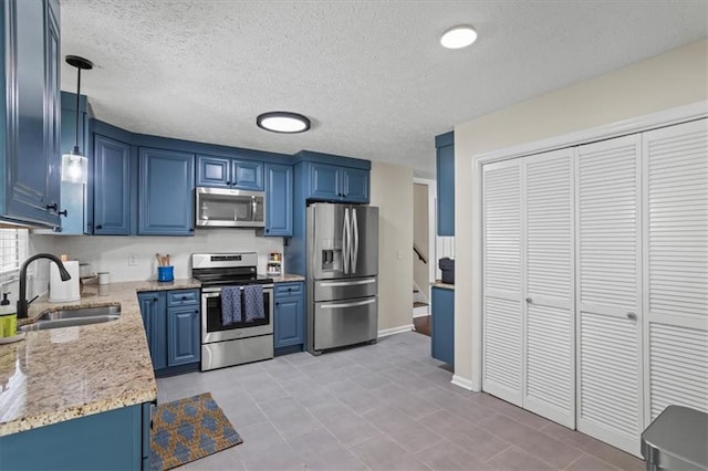 110 Village Ct, Woodstock, GA 30188 - kitchen featuring stainless steel appliances, blue cabinets, light stone counters, light tile patterned flooring, and a textured ceiling
