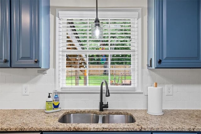 110 Village Ct, Woodstock, GA 30188 - kitchen with blue cabinetry, backsplash, and light stone countertops