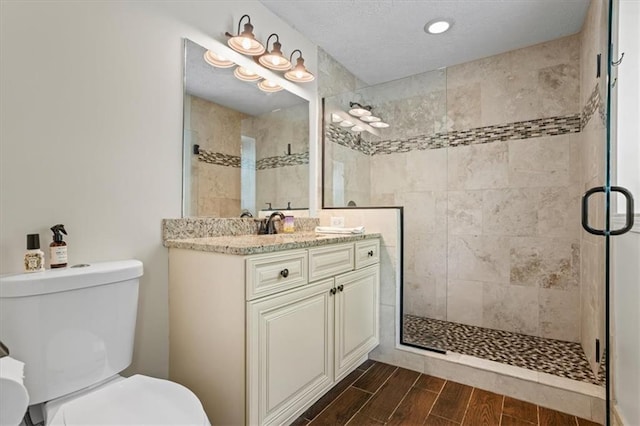 110 Village Ct, Woodstock, GA 30188 - bathroom with vanity, a shower stall, wood tiled floors, and recessed lighting