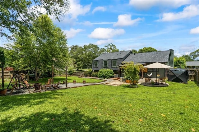 110 Village Ct, Woodstock, GA 30188 - rear view of house with a patio, an outdoor fire pit, a fenced backyard, and a shingled roof