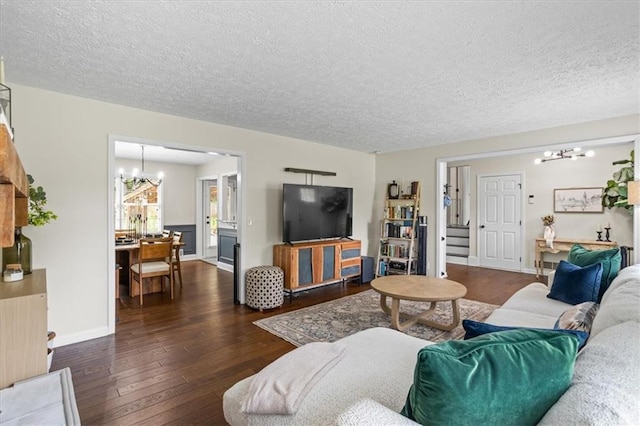 110 Village Ct, Woodstock, GA 30188 - living room with a chandelier, a textured ceiling, dark wood-style flooring, and stairs
