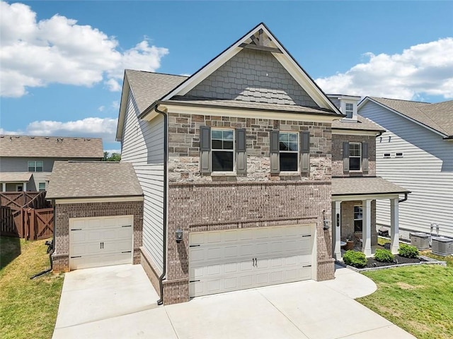 66 Cottontail Ln, Loganville, GA 30052 - craftsman-style home featuring driveway, a garage, stone siding, and brick siding