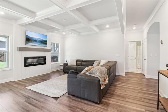66 Cottontail Ln, Loganville, GA 30052 - living area featuring a large fireplace, arched walkways, wood finished floors, baseboards, and recessed lighting