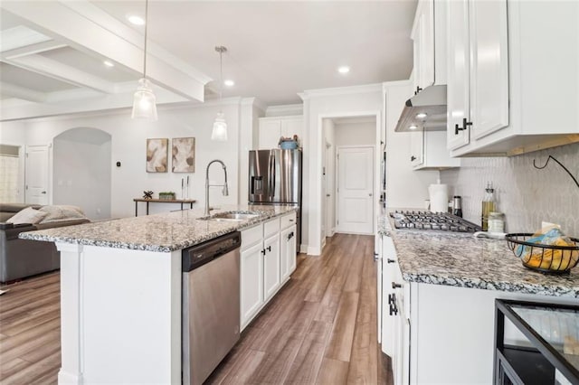 66 Cottontail Ln, Loganville, GA 30052 - kitchen featuring a sink, under cabinet range hood, appliances with stainless steel finishes, recessed lighting, and arched walkways