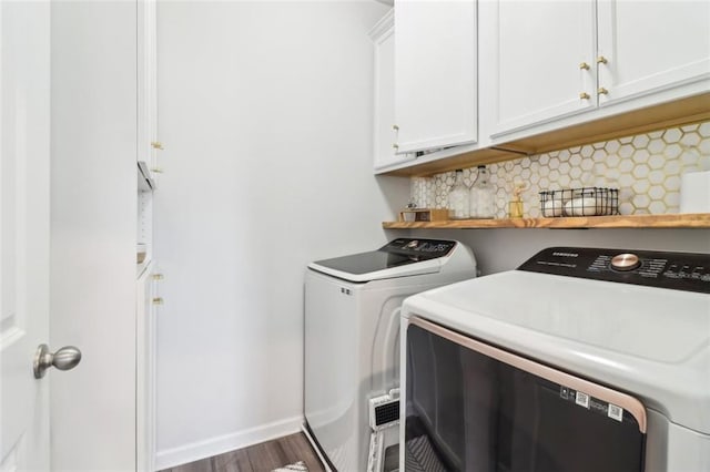 66 Cottontail Ln, Loganville, GA 30052 - washroom with washer and clothes dryer, cabinet space, wood finished floors, and baseboards