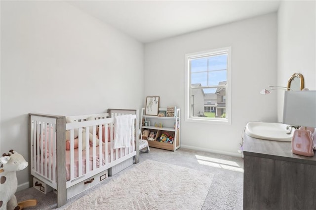 66 Cottontail Ln, Loganville, GA 30052 - carpeted bedroom featuring a crib, a sink, and baseboards