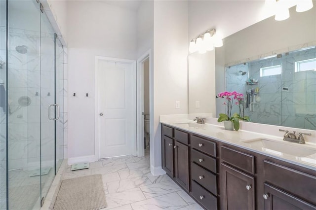66 Cottontail Ln, Loganville, GA 30052 - bathroom featuring a marble finish shower, a spacious closet, baseboards, double vanity, and marble finish floors