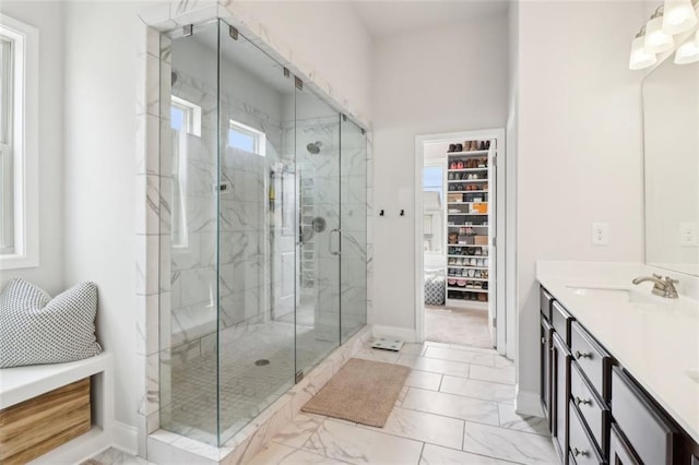 66 Cottontail Ln, Loganville, GA 30052 - bathroom featuring marble finish floors, a marble finish shower, baseboards, and vanity