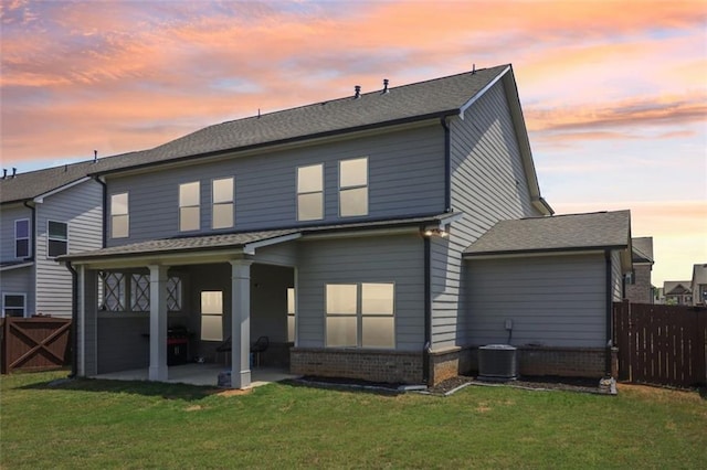 66 Cottontail Ln, Loganville, GA 30052 - back of property with a patio area, brick siding, central AC unit, and roof with shingles