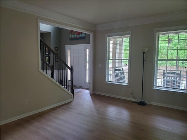 entrance foyer with baseboards, stairs, and wood finished floors