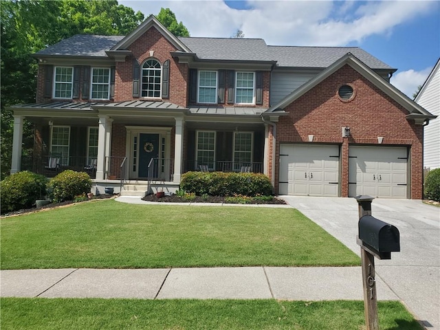 view of front of property with concrete driveway, a front lawn, brick siding, and an attached garage