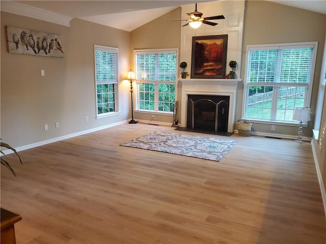 unfurnished living room with lofted ceiling, a ceiling fan, a large fireplace, and wood finished floors