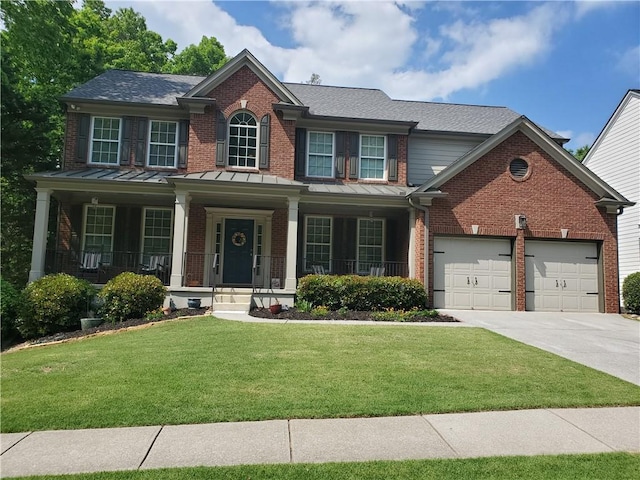 view of front facade featuring driveway, a standing seam roof, brick siding, and a garage