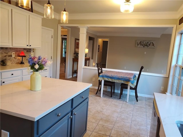 kitchen with ornate columns, crown molding, white cabinetry, decorative backsplash, and blue cabinetry