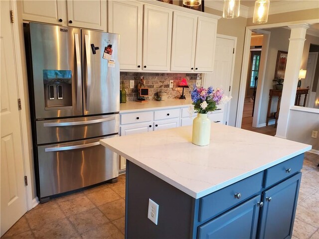 kitchen featuring blue cabinets, stainless steel fridge, backsplash, white cabinets, and ornate columns