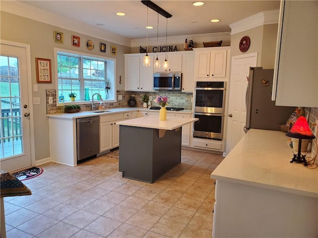 kitchen featuring light countertops, white cabinets, appliances with stainless steel finishes, and decorative backsplash