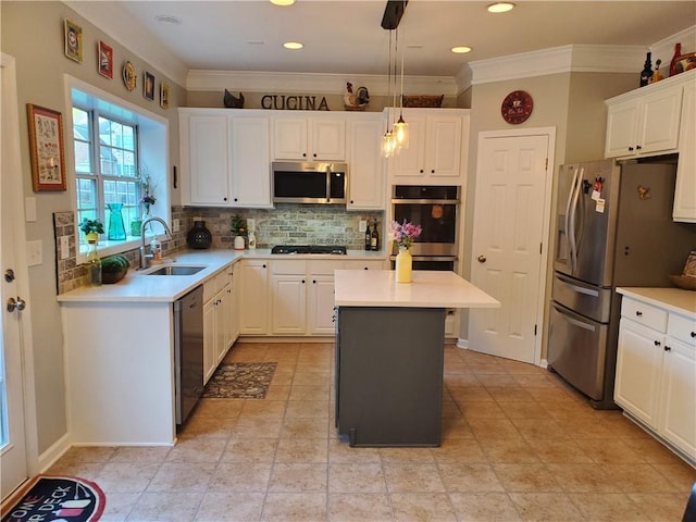 kitchen featuring a center island, white cabinets, appliances with stainless steel finishes, and a sink