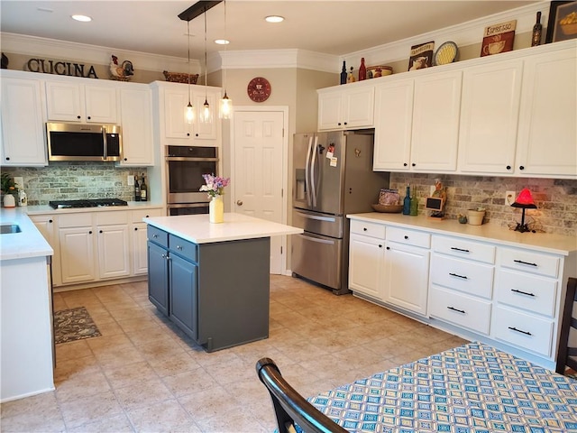 kitchen featuring white cabinetry, crown molding, tasteful backsplash, and appliances with stainless steel finishes