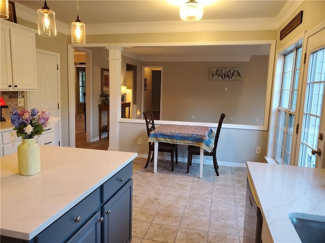 kitchen featuring white cabinetry, ornamental molding, light stone countertops, and blue cabinetry