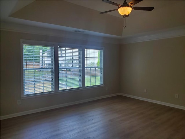 unfurnished room featuring baseboards, a wealth of natural light, visible vents, and wood finished floors