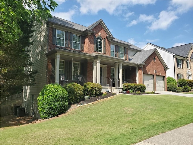 view of front of property with driveway, brick siding, covered porch, and a front yard