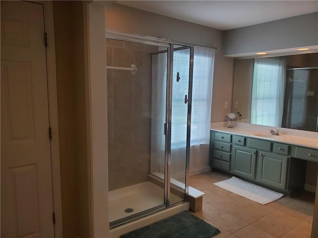 full bathroom featuring tile patterned flooring, a shower stall, and vanity
