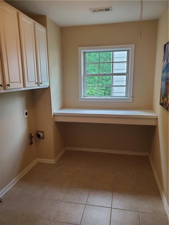 laundry room with cabinet space, visible vents, light tile patterned flooring, and electric dryer hookup