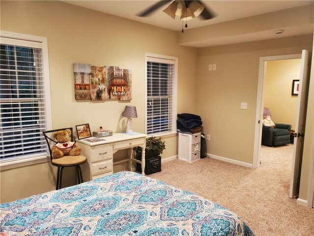 carpeted bedroom featuring baseboards and ceiling fan