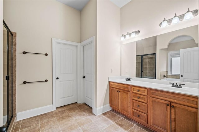 bathroom featuring walk in shower, tile patterned floors, and vanity