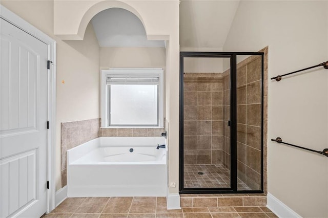 bathroom with tile patterned flooring and separate shower and tub