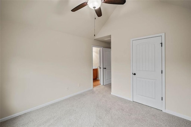 unfurnished bedroom with ceiling fan, light colored carpet, lofted ceiling, and connected bathroom