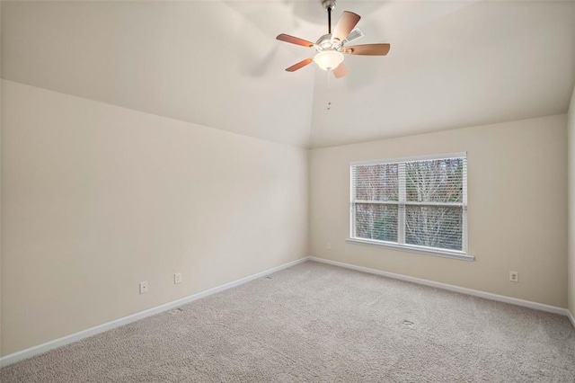 spare room featuring carpet floors, ceiling fan, and vaulted ceiling