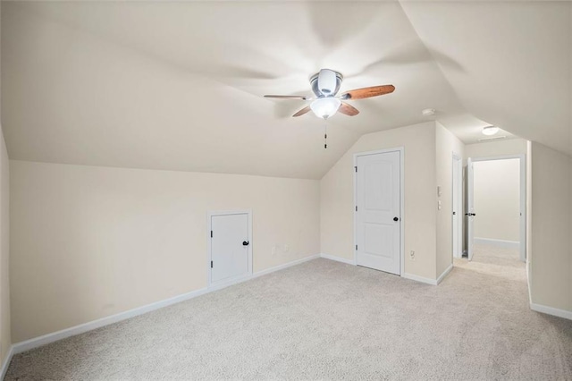 bonus room with light carpet, lofted ceiling, and ceiling fan