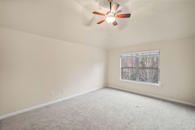 carpeted empty room featuring vaulted ceiling and ceiling fan