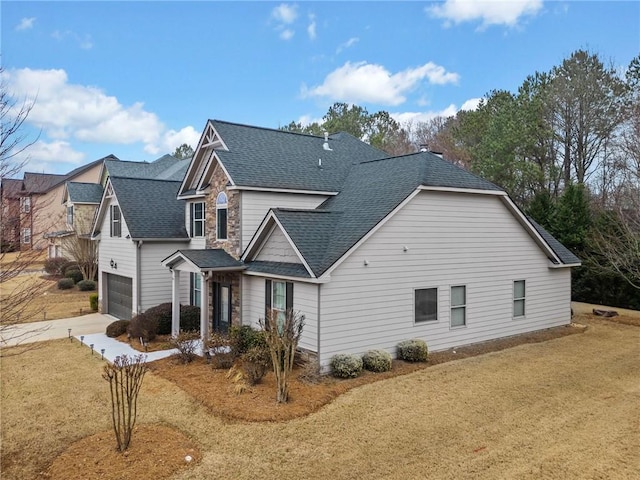 view of front of home with a garage and a front lawn