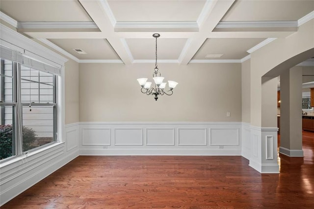 spare room with an inviting chandelier, dark wood-type flooring, coffered ceiling, and beamed ceiling