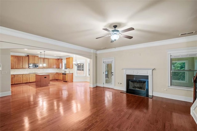 unfurnished living room featuring ceiling fan, ornamental molding, and light hardwood / wood-style flooring