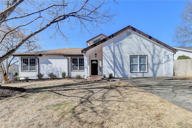 ranch-style home featuring a front yard