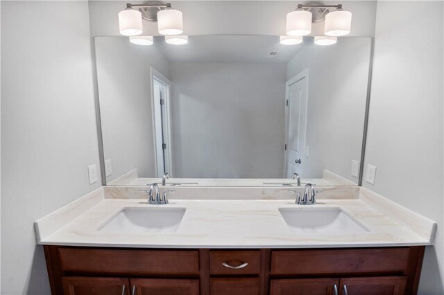 bathroom featuring an inviting chandelier and vanity