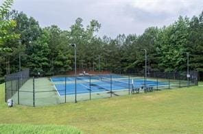 view of tennis court with a lawn