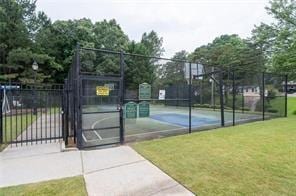 view of sport court with a yard