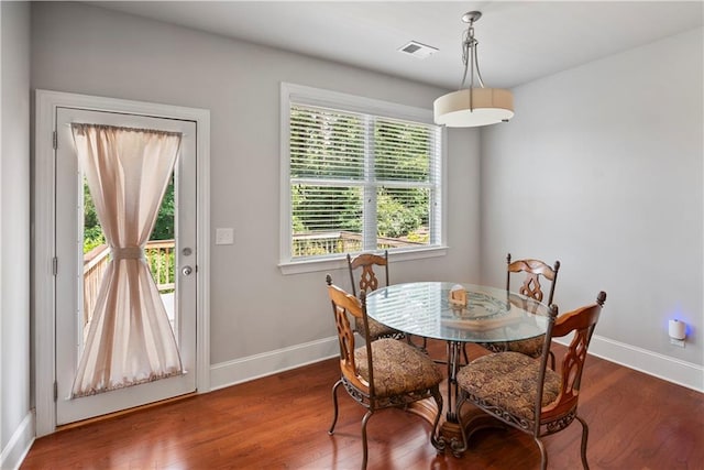 dining space featuring dark hardwood / wood-style floors