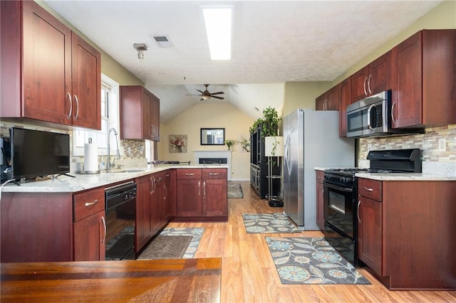 3090 Perch Ln SW, Marietta, GA 30008 - kitchen featuring black appliances, a sink, light wood-style floors, a peninsula, and backsplash